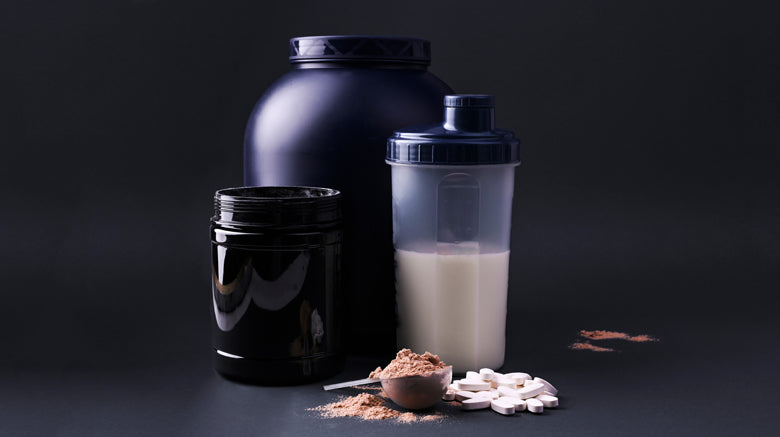 tub of protein powder and shaker and sports supplements