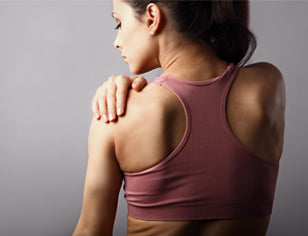 Woman in sports top doing a stretch