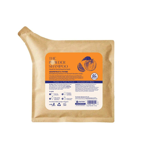 The Powder Shampoo package with an orange label on a white background