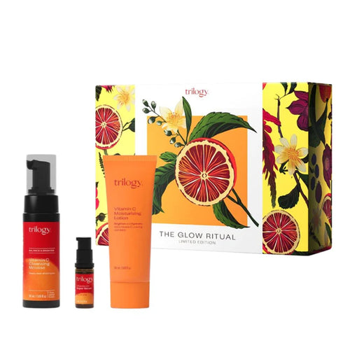 Trilogy skincare product set with colorful packaging on a white background