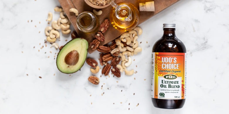 Bottle of Udo's choice ultimate oil blend with selection of nuts