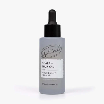 A bottle of UpCircle Scalp + Hair Oil