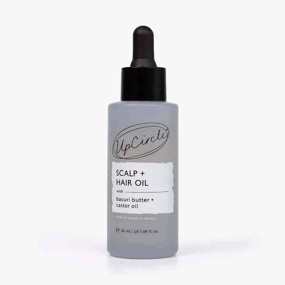 A bottle of UpCircle Scalp + Hair Oil