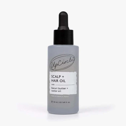 A bottle of UpCircle Scalp + Hair Oil