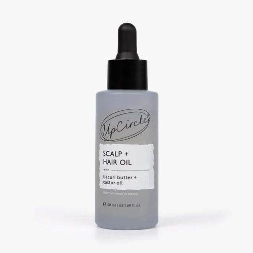 A bottle of UpCircle Scalp + Hair Oil
