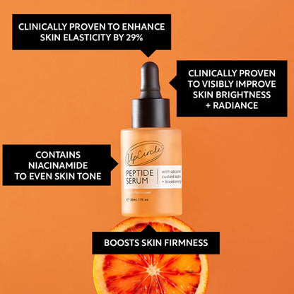 UpCircle peptide serum bottle with orange slices on an orange background