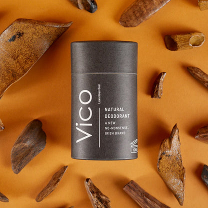 Vico natural deodorant stick on an orange background with natural elements
