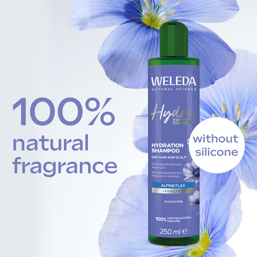 Weleda shampoo bottle with blue flowers and text highlighting natural fragrance and silicone-free ingredients.