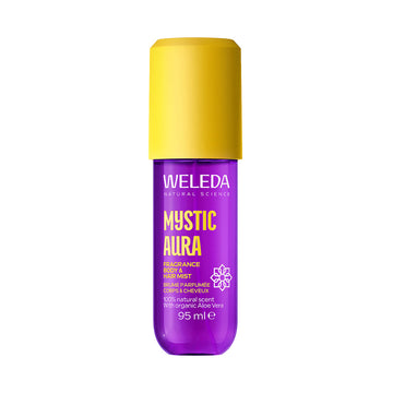A bottle of Weleda Mystic Aura Fragrance Body &amp; Hair Mist, featuring a vibrant purple bottle and a bright yellow cap, set against a plain white background.