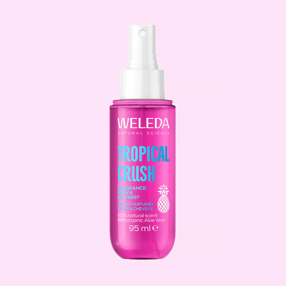 A bottle of Weleda Tropical Crush perfume mist spray.