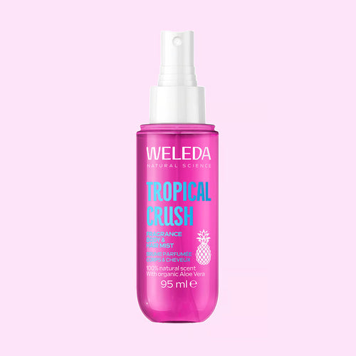 A bottle of Weleda Tropical Crush perfume mist spray.