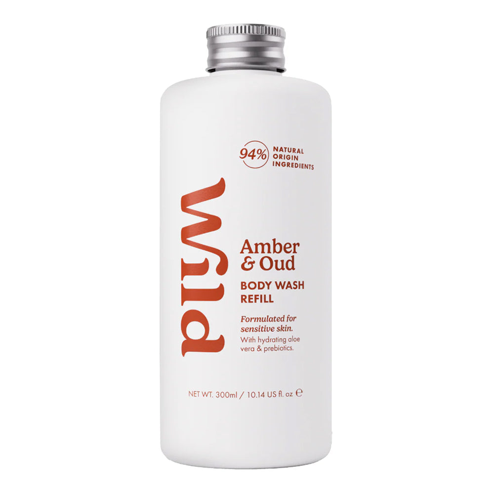A 300ml white bottle of Wild Body Wash Refill in the Amber &amp; Oud scent, featuring a silver screw cap and orange-red text on a clean white background.