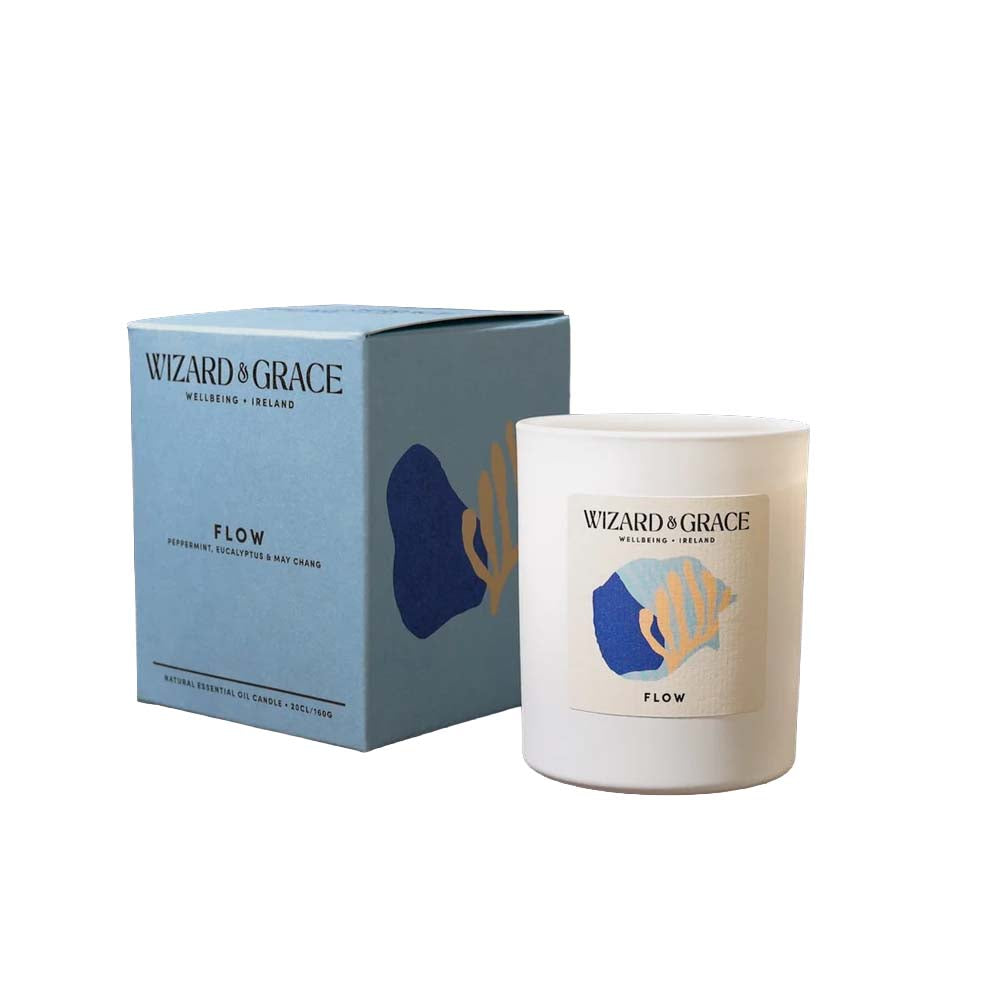 Wizard &amp; Grace "FLOW" natural essential oil candle in a white jar next to its light blue packaging box, scented with peppermint, eucalyptus, and may chang.