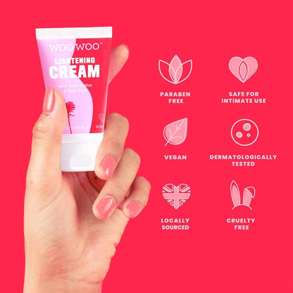 Hand holding a tube of Woowoo Lightening Cream against a red background with product features listed.