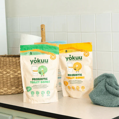 Two packages of yokuu probiotic toilet bombs on a bathroom counter.